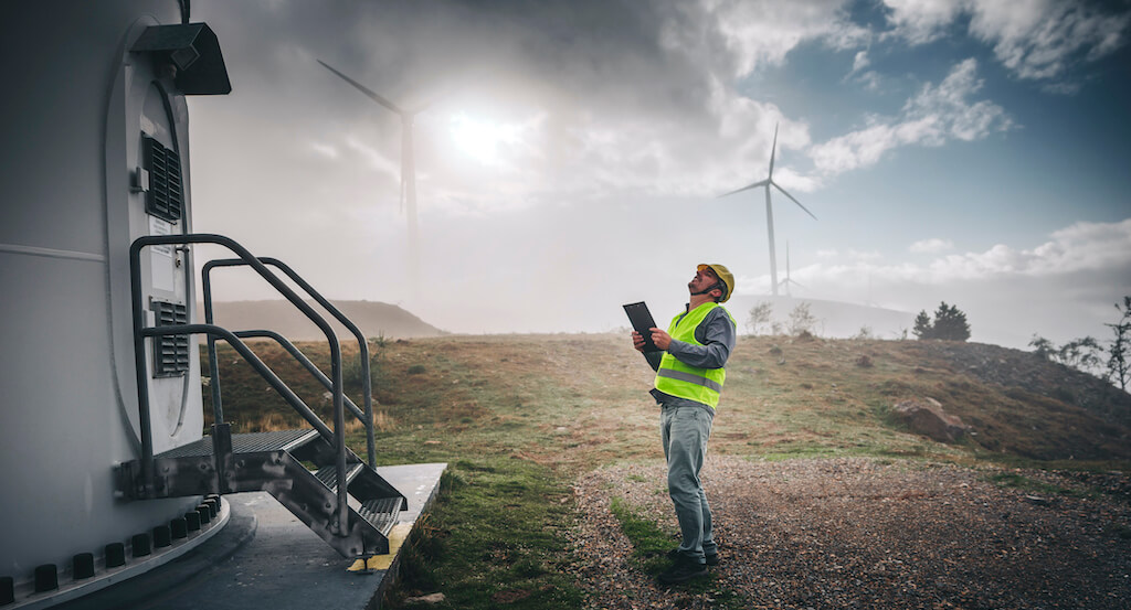 Man-looking-at-wind-turbine-data-storage